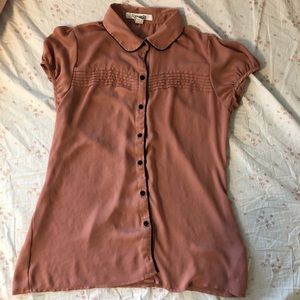 adorable nude colored blouse with black detail.